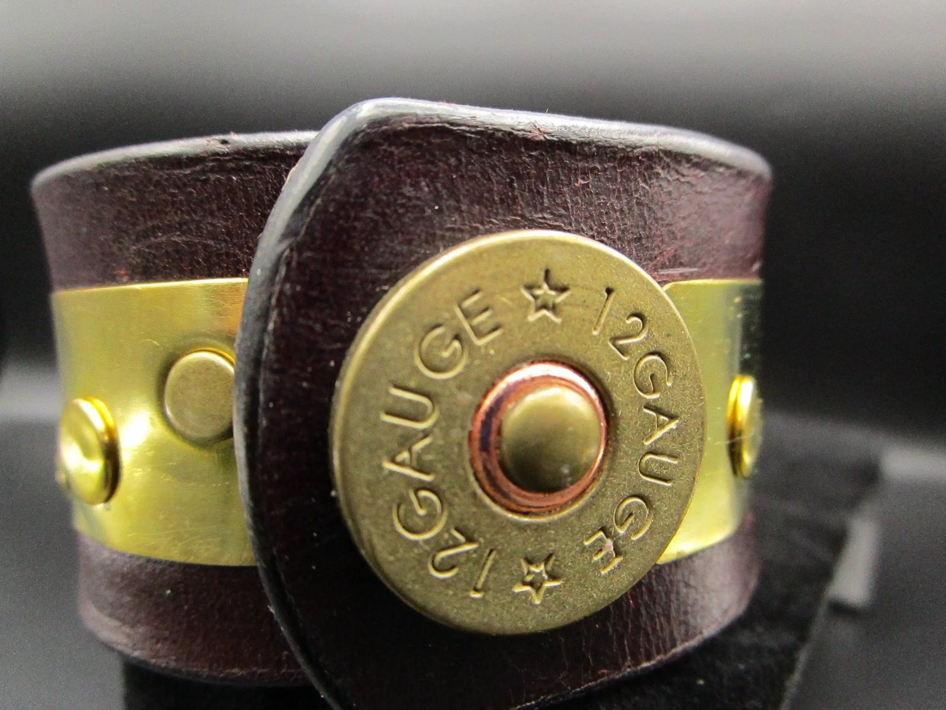 close up of genuine brown leather bracelet and 12 Gauge bullet shell snap